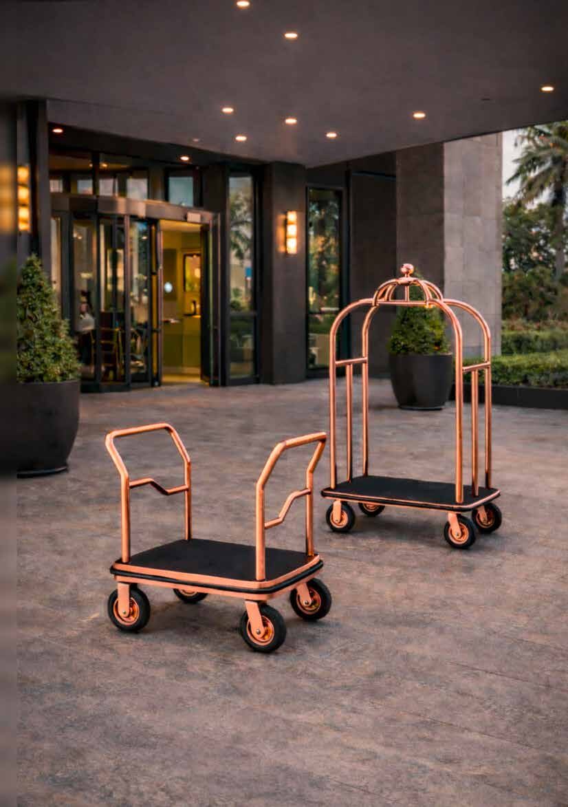 Storn rose-gold birdcage luggage carts at a hotel entrance